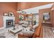 Inviting living room featuring a cozy fireplace and an open concept to the dining area at 548 Thomas Downs Way, Jonesboro, GA 30238