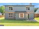 The rear exterior of the home features a sliding glass door that leads to a concrete patio and a well-manicured lawn at 548 Thomas Downs Way, Jonesboro, GA 30238