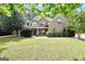 A daytime view of this property with its lush yard, sculpted bushes, and trees at 204 Carmell Ct, Mcdonough, GA 30252