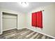 Well-lit bedroom with wood-look floors and a closet perfect for storage at 758 King Rd, Jonesboro, GA 30236