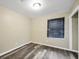 Cozy bedroom featuring neutral walls, wood-look flooring, and a window with wood blinds at 758 King Rd, Jonesboro, GA 30236