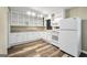 Bright kitchen with white cabinetry, modern appliances, and new flooring at 758 King Rd, Jonesboro, GA 30236