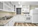 Bright kitchen with white cabinetry, stainless steel appliances, and granite counters at 758 King Rd, Jonesboro, GA 30236