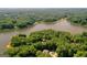 Breathtaking aerial view of a lakefront property surrounded by lush greenery and offering ultimate privacy at 127 Darwish Dr, Mcdonough, GA 30252