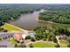 Aerial view showcases community amenities: pool, tennis courts, a club house, and lake access at 127 Darwish Dr, Mcdonough, GA 30252