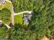Aerial view of the home, showcasing the roof, lawn, driveway, and surrounding trees at 127 Darwish Dr, Mcdonough, GA 30252