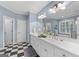 Bathroom featuring dual vanity, decorative mirrors and black and white checkered floor at 127 Darwish Dr, Mcdonough, GA 30252