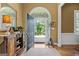 Inviting foyer featuring hardwood floors, a decorative rug, and an open doorway showcasing lush greenery at 127 Darwish Dr, Mcdonough, GA 30252