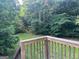 Relax on the deck with a view of the expansive tree-lined backyard at 7138 Rockland Rd, Lithonia, GA 30038