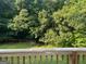 Enjoy the expansive, tree-lined backyard from the wood-railed deck at 7138 Rockland Rd, Lithonia, GA 30038