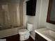 Bathroom featuring a tub with shower, toilet, vanity, and a wall cabinet at 7138 Rockland Rd, Lithonia, GA 30038