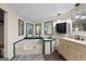 Bright bathroom featuring a soaking tub, marble countertop, and multiple mirrors for ample natural light at 7138 Rockland Rd, Lithonia, GA 30038