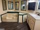 Bathroom with a triangular tub, modern vanity and lighting at 7138 Rockland Rd, Lithonia, GA 30038