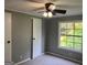 Bedroom featuring a window for natural light and a ceiling fan for comfort at 7138 Rockland Rd, Lithonia, GA 30038