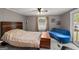 Comfortable bedroom featuring neutral colors, a ceiling fan and a sliding glass door to the outside deck at 7138 Rockland Rd, Lithonia, GA 30038
