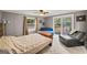 Comfortable bedroom featuring neutral colors, a ceiling fan and a sliding glass door to the outside deck at 7138 Rockland Rd, Lithonia, GA 30038