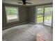 Bright bedroom featuring neutral carpet and sliding glass doors leading to a deck at 7138 Rockland Rd, Lithonia, GA 30038