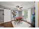 Dining area featuring wood floors, natural light, a sliding barn door and a ceiling fan at 7138 Rockland Rd, Lithonia, GA 30038