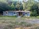 The exterior of the home showing the mature landscaping and spacious yard at 7138 Rockland Rd, Lithonia, GA 30038