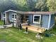 Attractive home with a stone-accented entrance, a small deck, and freshly mulched landscaping at 7138 Rockland Rd, Lithonia, GA 30038