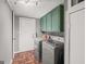 Convenient laundry room with washer, dryer, and cabinet space near the doorway at 7138 Rockland Rd, Lithonia, GA 30038