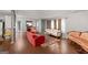 Cozy living room featuring wood floors, vintage furniture, and a spacious layout at 7138 Rockland Rd, Lithonia, GA 30038
