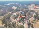 Aerial neighborhood view showcases a golf course, lake, and established homes with mature trees at 8870 Dornoch Cir, Winston, GA 30187
