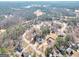Scenic aerial view of a neighborhood featuring established homes surrounded by mature trees and a nearby golf course at 8870 Dornoch Cir, Winston, GA 30187