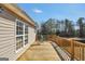 Back deck featuring wood flooring, railings, and two chairs offers outdoor relaxation with tree views at 8870 Dornoch Cir, Winston, GA 30187