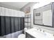 Well-lit bathroom with a sleek vanity, mirror, and shower-tub features modern fixtures and finishes at 8870 Dornoch Cir, Winston, GA 30187