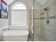 Relaxing bathroom featuring a soaking tub, walk-in shower, and neutral color palette at 8870 Dornoch Cir, Winston, GA 30187
