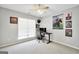 Bright bedroom with a ceiling fan, a large window, and a desk is perfect for sleep or work at 8870 Dornoch Cir, Winston, GA 30187