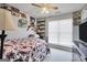 Cozy bedroom with a floral bedspread, bright window, and personal decorative touches at 8870 Dornoch Cir, Winston, GA 30187