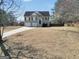 Two-story home featuring a two-car garage and stairway to front door on a sunny day at 8870 Dornoch Cir, Winston, GA 30187