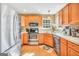 Functional kitchen with wood cabinets, stainless steel appliances, and ample countertop space at 8870 Dornoch Cir, Winston, GA 30187