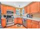 Well-equipped kitchen boasts stainless appliances, wood cabinets, and a convenient layout at 8870 Dornoch Cir, Winston, GA 30187