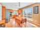 Bright kitchen featuring wood cabinetry, stainless steel appliances, and a sunlit dining area at 8870 Dornoch Cir, Winston, GA 30187