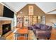 Vaulted living room featuring a fireplace, television, hardwood floors, and ample seating at 8870 Dornoch Cir, Winston, GA 30187