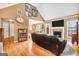 Spacious living room with a fireplace, television, hardwood floors, and lots of natural light at 8870 Dornoch Cir, Winston, GA 30187