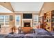 Bright living room boasts fireplace, tv, hardwood floors, and large window at 8870 Dornoch Cir, Winston, GA 30187