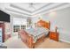 Inviting main bedroom featuring a tray ceiling, plush carpet, and a well-lit window at 8870 Dornoch Cir, Winston, GA 30187