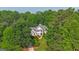 Charming two-story home surrounded by verdant trees and landscaping, creating a secluded and picturesque setting at 104 Hidden Springs Ln, Peachtree City, GA 30269