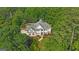 Stunning aerial view of a two-story home with a swimming pool surrounded by lush greenery at 104 Hidden Springs Ln, Peachtree City, GA 30269