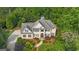 An aerial perspective shows a home with meticulous landscaping, a multi-car garage and a gunite pool at 104 Hidden Springs Ln, Peachtree City, GA 30269