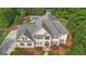 Aerial view showing meticulous landscaping, multilevel patio, and gunite pool, creating a private outdoor retreat at 104 Hidden Springs Ln, Peachtree City, GA 30269
