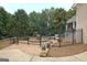 Private backyard with a manicured lawn, ornamental fountain, and mature landscaping at 104 Hidden Springs Ln, Peachtree City, GA 30269