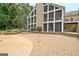 Spacious backyard featuring an expansive stone patio and well-maintained landscaping, perfect for outdoor entertaining at 104 Hidden Springs Ln, Peachtree City, GA 30269