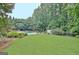 Expansive backyard with a well-maintained lawn and mature trees surrounding the property at 104 Hidden Springs Ln, Peachtree City, GA 30269