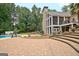 Gorgeous backyard featuring a screened porch, pool, and stone patio, perfect for outdoor living and relaxation at 104 Hidden Springs Ln, Peachtree City, GA 30269