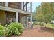 Beautiful backyard featuring a screened porch, lush landscaping, and serene outdoor space at 104 Hidden Springs Ln, Peachtree City, GA 30269